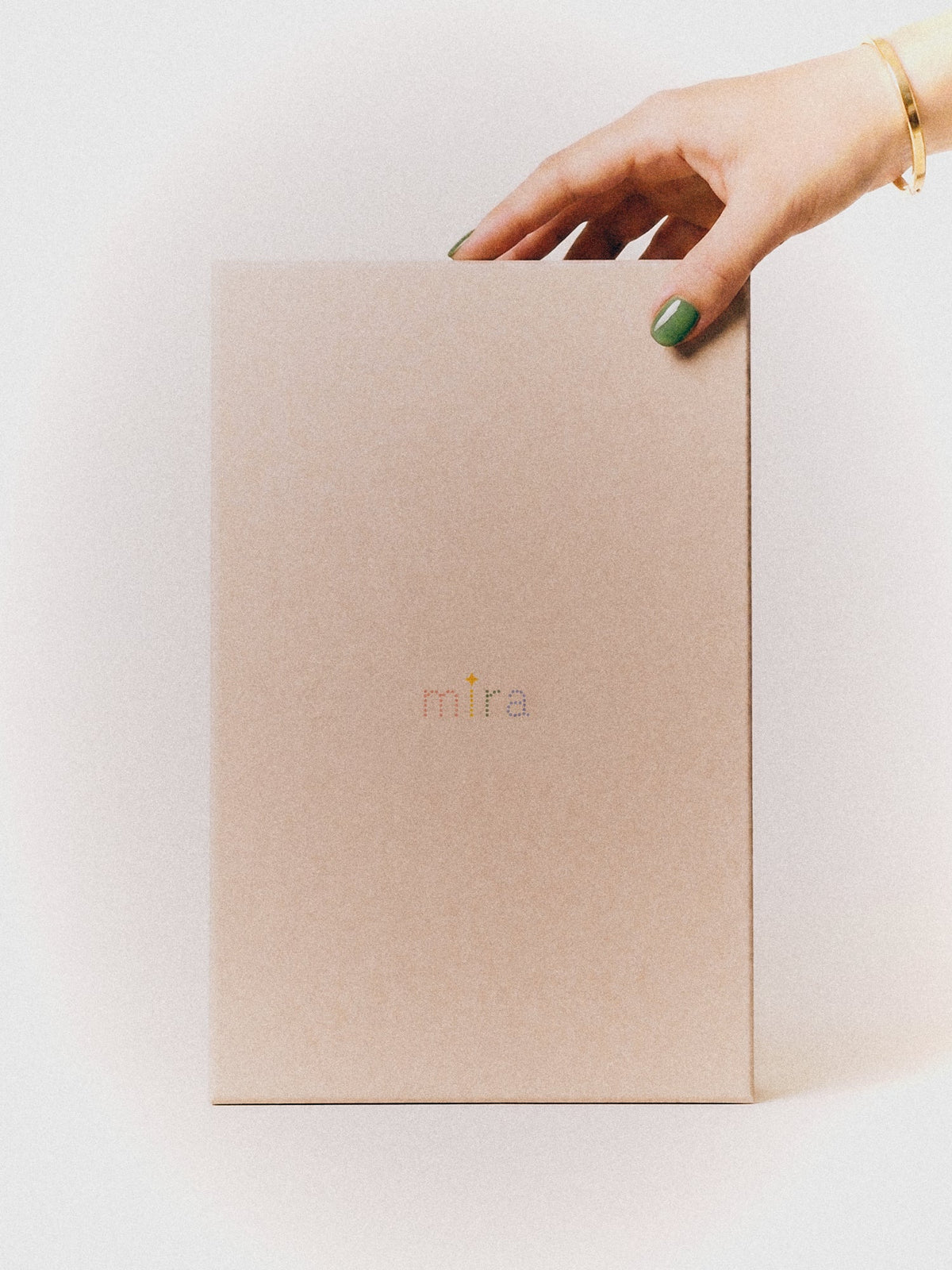The Mira Box, closed, held in one hand